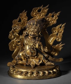 A GILT-BRONZE FIGURE OF SEATED MAHAKALA