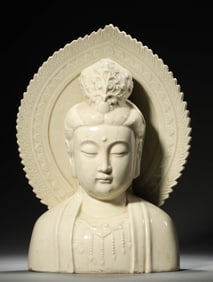 A WHITE-GLAZED BUST OF GUANYIN