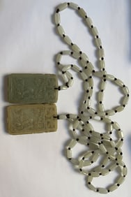 A PAIR OF HETIAN JADE PENDANTS