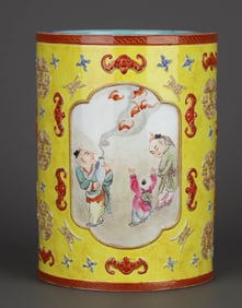 A YELLOW-GLAZED CARVED AND GILT DECORATED 'FLORAL AND CHILDREN' BRUSH POT