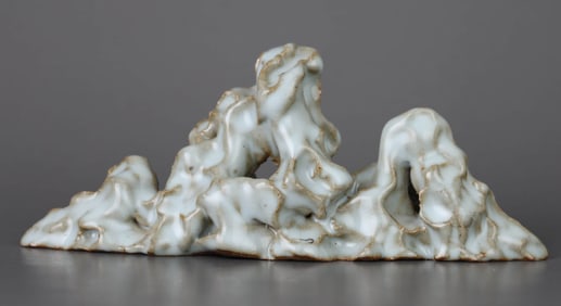 A CELADON GLAZED STONE MOUNTAIN SHAPED BRUSH HOLDER