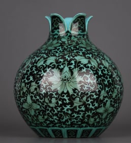 A GREEN-GLAZED INK-PAINTED 'LOTUS' POMEGRANATE SHAPED VASE