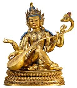 A COPPER-GILT BUDDHA STATUE