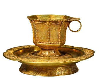 A SILVER-GILT CUP AND SAUCER
