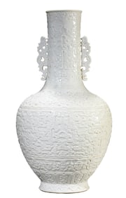 A WHITE-GLAZED CARVED 'DRAGON AND PHOENIX' VASE