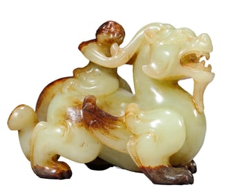 A JADE CARVED WINGED FIGURE RIDING BEAST