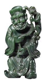 A JADEITE CARVED BARBARIAN