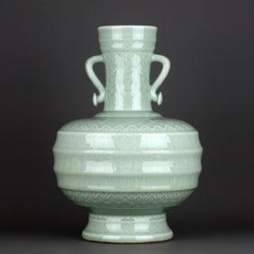 A CELADON-GLAZED CARVED 'FISH AND SHOU' VASE