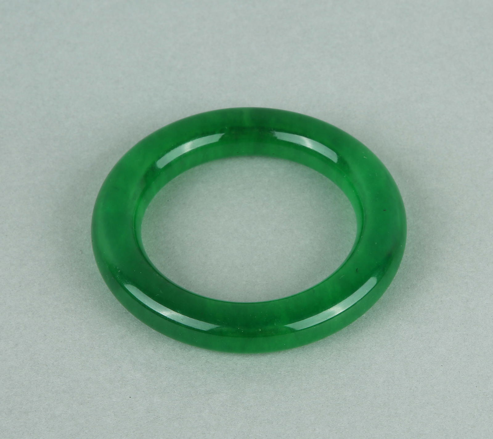 A BRACELET: A JADEITE BRACELET Dimensions: Inner Diameter: 5.5 cm (2.17 in.). All measurements are approximate.Any condition statement is given as a courtesy to a client, is only an opinion and should not be trea