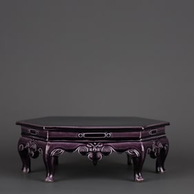 AN AUBERGINE-GLAZED CARVED 'FLORAL AND RUYI' HEXAGONAL PORCELAIN TABLE