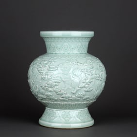 A CELADON-GLAZED CARVED 'CLOUDS AND LIONS' LANTERN-SHAPED VASE