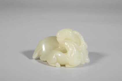 A CELADON JADE FIGURE