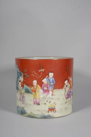 A RED GROUND FAMILLE ROSE 'PLAYING CHILDREN' BRUSH POT