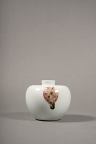 A UNDERGLAZED RED APPLE-SHAPED JAR