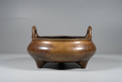 A BRONZE BRIDGE-HANDLE CENSER