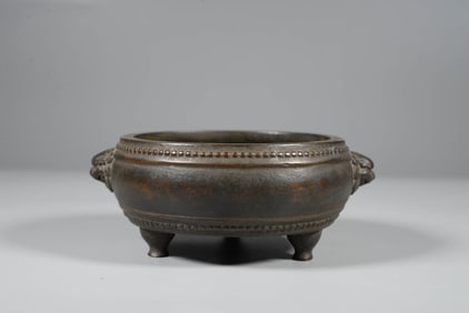 A BRONZE BEAST-HANDLE TRIPOD CENSER