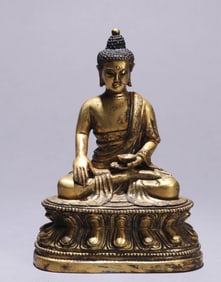 A GILT-BRONZE FIGURE OF BHAISHAJYAGURU BUDDHA