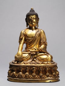 A GILT-BRONZE FIGURE OF SHAKYAMUNI BUDDHA