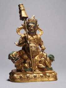 A GILT-BRONZE FIGURE OF JAMBHALA