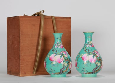 A PAIR OF GREEN GROUND FAMILLE-ROSE 'PEACH' VASES