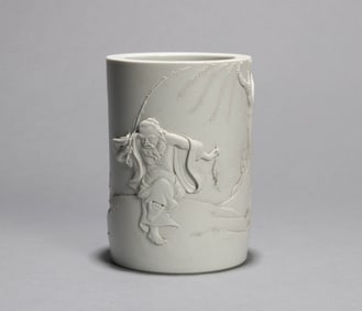 A CARVED 'FIGURE'BRUSHPOT