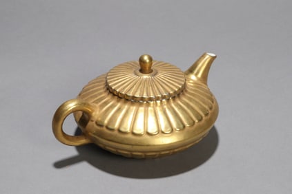 A GOLD-GLAZED CHRYSANTHEMUM SHAPED POT