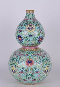 A GREEN-GROUND FAMILLE-ROSE 'FLORAL' GOURP SHAPED VASE