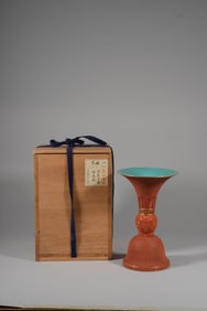 A CARVED-LACQUER-EFFECT PORCELAIN BEAKER VASE