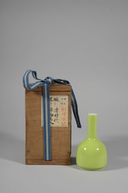 A GREEN GLAZED VASE