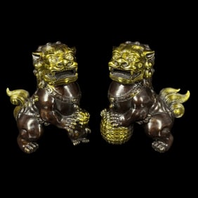 A PAIR OF BRONZE LION SCULPTURES