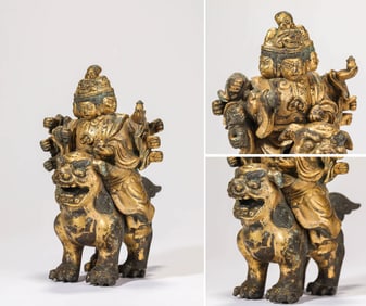 A GILT-BRONZE GUARDIAN KING
