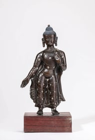 A BRONZE STANDING SHAKYAMUNI