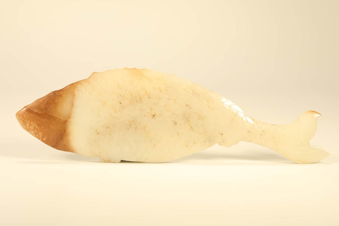 A HETIAN JADE 'JADE-SHAPED' CARVING: A HETIAN JADE 'JADE-SHAPED' CARVING Dimensions: Length: 25 cm (9.8 in.), Width: 7.5 cm (3 in.). All measurements are approximate. Any condition statement is given as a courtesy to a client, is only an