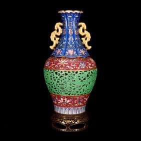 AN ENAMEL REVOLVING OPENWORK VASE