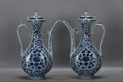 A PAIR OF BLUE AND WHITE 'INTERLOCKING LOTUS' EWERS