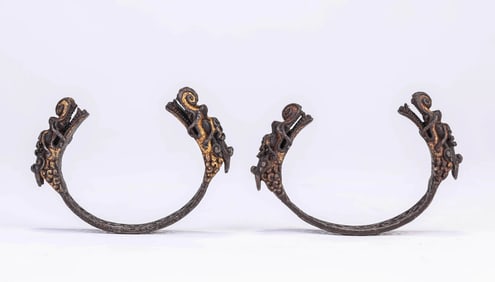 A PAIR OF TIBETAN IRON AND GOLD-INLAID OPENWORK 'DRAGON HEAD' BRACELETS