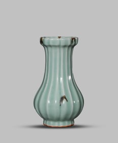 A CELADON-GLAZED MELON-SHAPED VASE