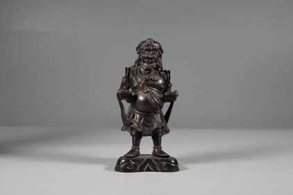 A BRONZE 'FOREIGNER OFFERING TREASURE' FIGURE