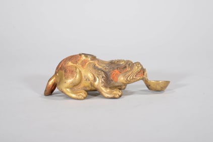 A GILT-BRONZE 'AUSPICIOUS BEAST' FIGURE