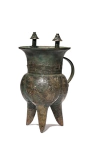 A BRONZE TRIPOD RITUAL WINE VESSEL (JIA) WITH TAOTIE MASK