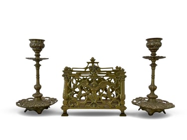 A SET OF BRASS OPENWORK RELIEF LETTER RACK AND CANDLESTICK