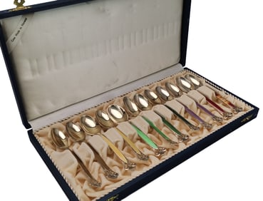 A SET OF SILVER GILT ENAMEL SPOONS