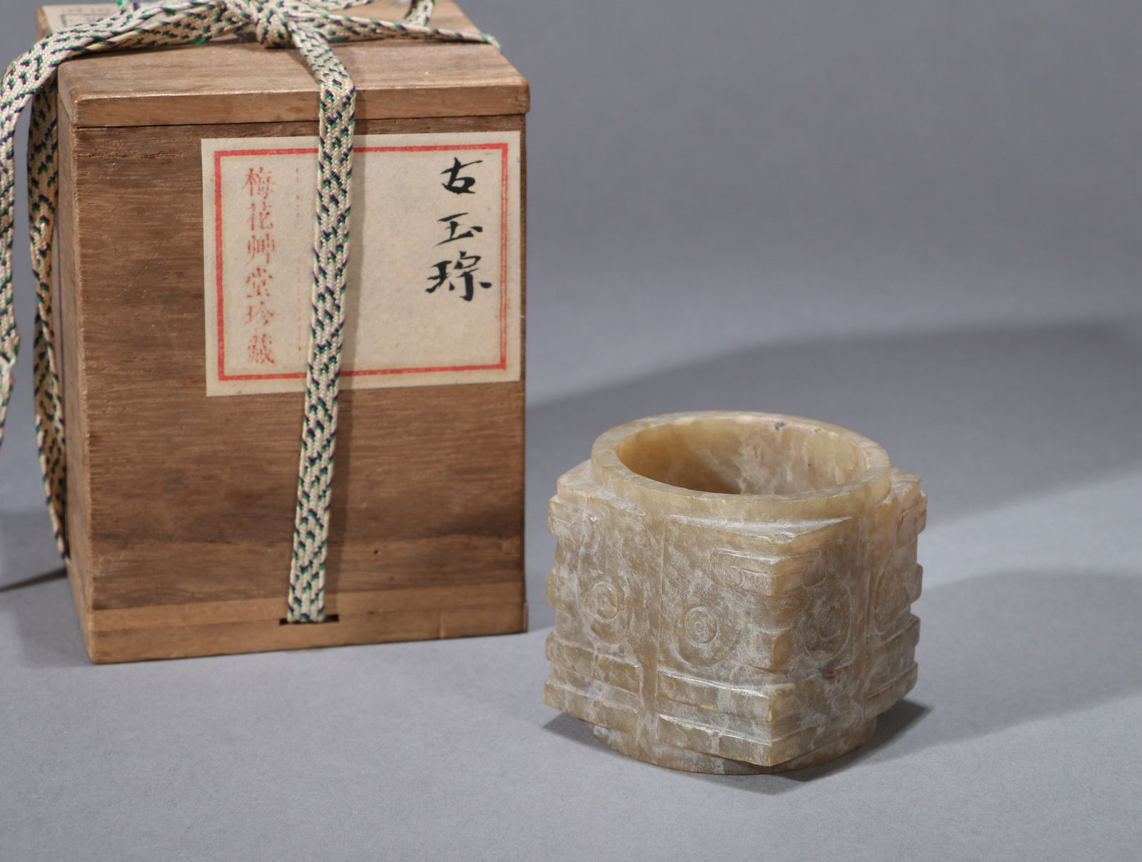 A JADE CONG WITH 'ANIMAL MASK': A JADE CONG WITH 'ANIMAL MASK' Dimensions: Height: 4.5 cm (1.8 in.). All measurements are approximate. Any condition statement is given as a courtesy to a client, is only an opinion and should not be