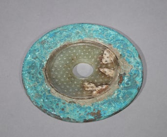 A BRONZE-INLAID JADE BI