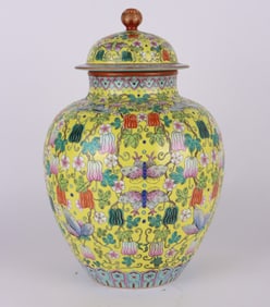 A YELLOW-GROUND FAMILLE ROSE 'MELON AND BUTTERFLY' COVERED JAR