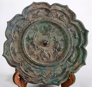 A TANG LOBED MIRROR WITH TWIN DRAGONS