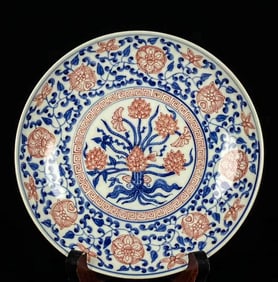 A BLUE AND WHITE WITH COPPER-RED 'INTERLOCKING FLOWERS AND LOTUS' DISH