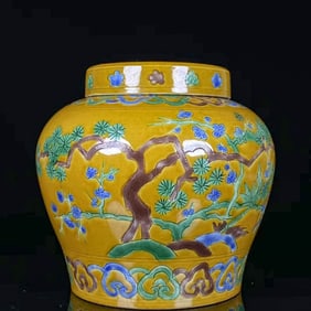 A SANCAI CARVED 'PINE, BAMBOO AND PLUM'  JAR