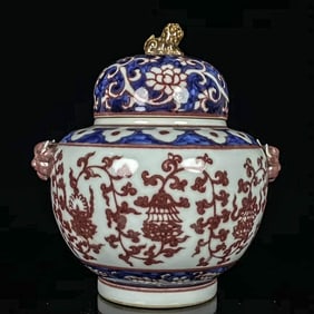 A BLUE AND WHITE WITH COPPER-RED 'INTERLOCKING FLOWERS AND BABAO' COVERED JAR