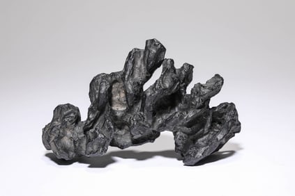 A BLACK-GLAZED MOUNTAIN ORNAMENT